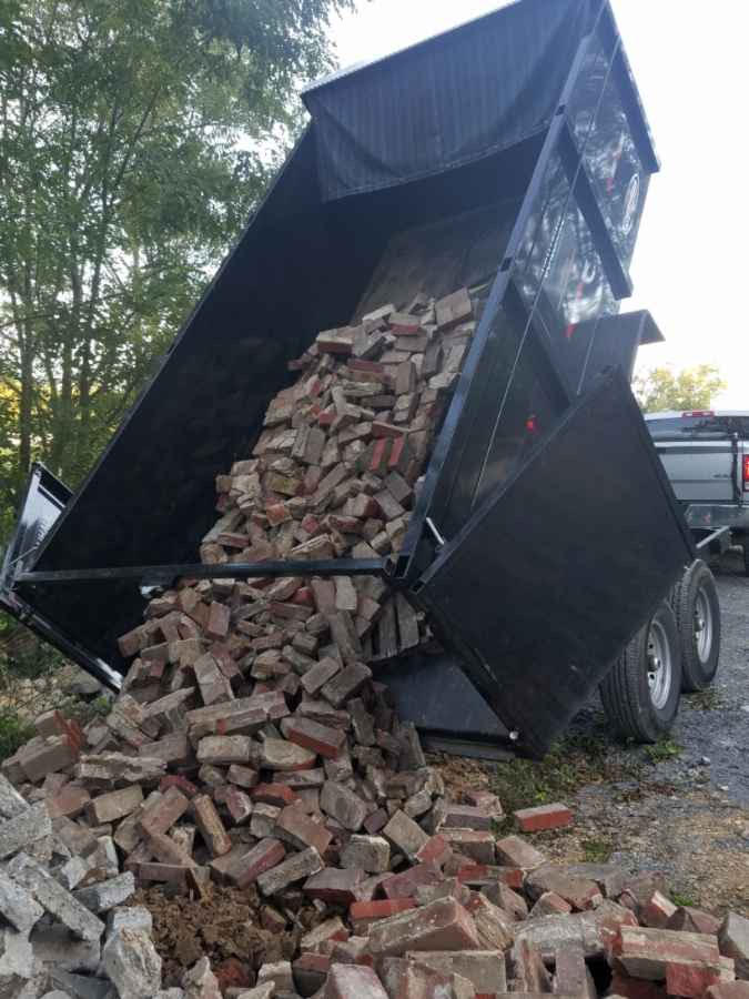 Oahu dump run truck dumping out concrete debris