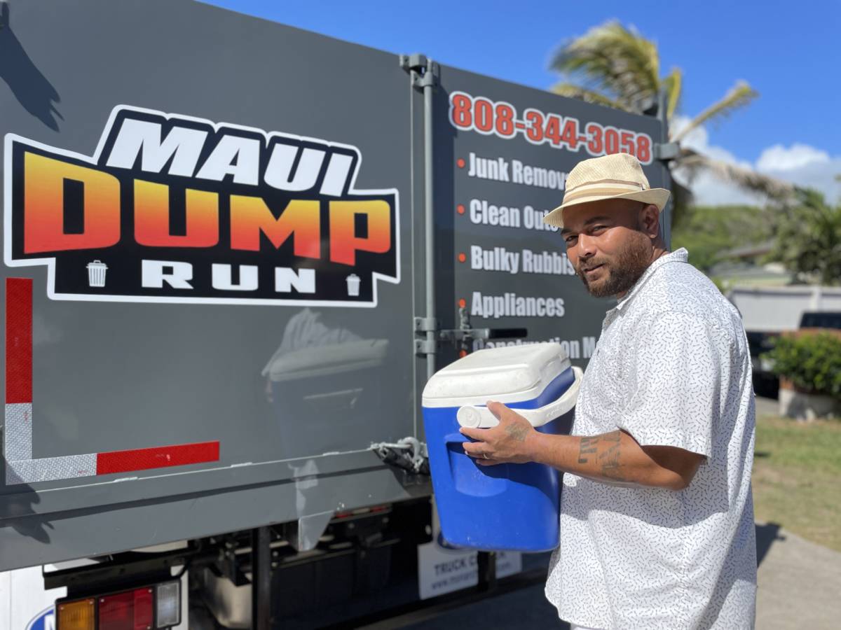 A professional from Maui Dump Run hauling junk to the Maui Dump Run truck